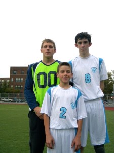 Danny Goncalves is pictured with a few of his taller teammates: senior goalie Robert Zawadzki, left, and sophomore midfielder/striker Brian Hickey, right. (Photo by Jim Mancari)