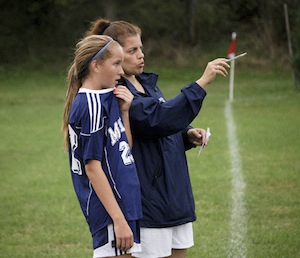 Archbishop Molloy H.S. girls’ varsity soccer coach Judy Zink, right, is shown giving instructions to senior team co-captain Kelly Grogan, left. (Photo courtesy Judy Zink)