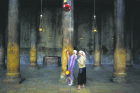 A tourist takes a photograph in the Church of the Nativity, the site revered as the birthplace of Jesus, in the West Bank town of Bethlehem June 28. The U.N. Educational, Scientific and Cultural Organization declared parts of Bethlehem and the church endangered World Heritage sites to expedite funding for repairs. (CNS photo/Ammar Awad, Reuters)