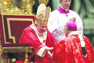 Pope Benedict XVI presents a pallium to Philadelphia Archbishop Charles J. Chaput during a Mass in St. Peter's Basilica at the Vatican June 29. The pope gave 44 archbishops the woolen pallium as a sign of their communion with him and their pastoral responsibility as shepherds. (CNS photo/Stefano Rellandini, Reuters)