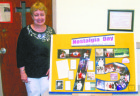 Third generation parishioner Deidre Andrews is shown alongside a display prepared by fellow parishioner Catherine Gregory. (Photo (C) Eugene Gregory)