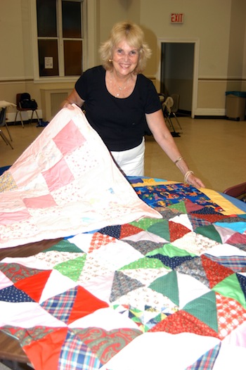 Maureen Walsh shows off some her quilts. (Photo © Marie Elena Giossi)