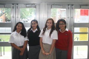 New McClancy students, from left, Tatiana Plasencia, Kayla Johnson, Davina Saltos and Alexia Mikellides pose in the school’s lobby on their first full day of school. (Photo by Tom Hopkins/Msgr. McClancy M.H.S.)