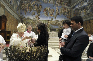Pope Benedict XVI baptizes a baby during a Mass in the Sistine Chapel at the Vatican Jan. 13. The pope baptized 20 babies as he celebrated the feast of the Baptism of the Lord. The pope told parents that baptism would bring their children into a “personal relationship with Jesus” that would give their lives meaning.