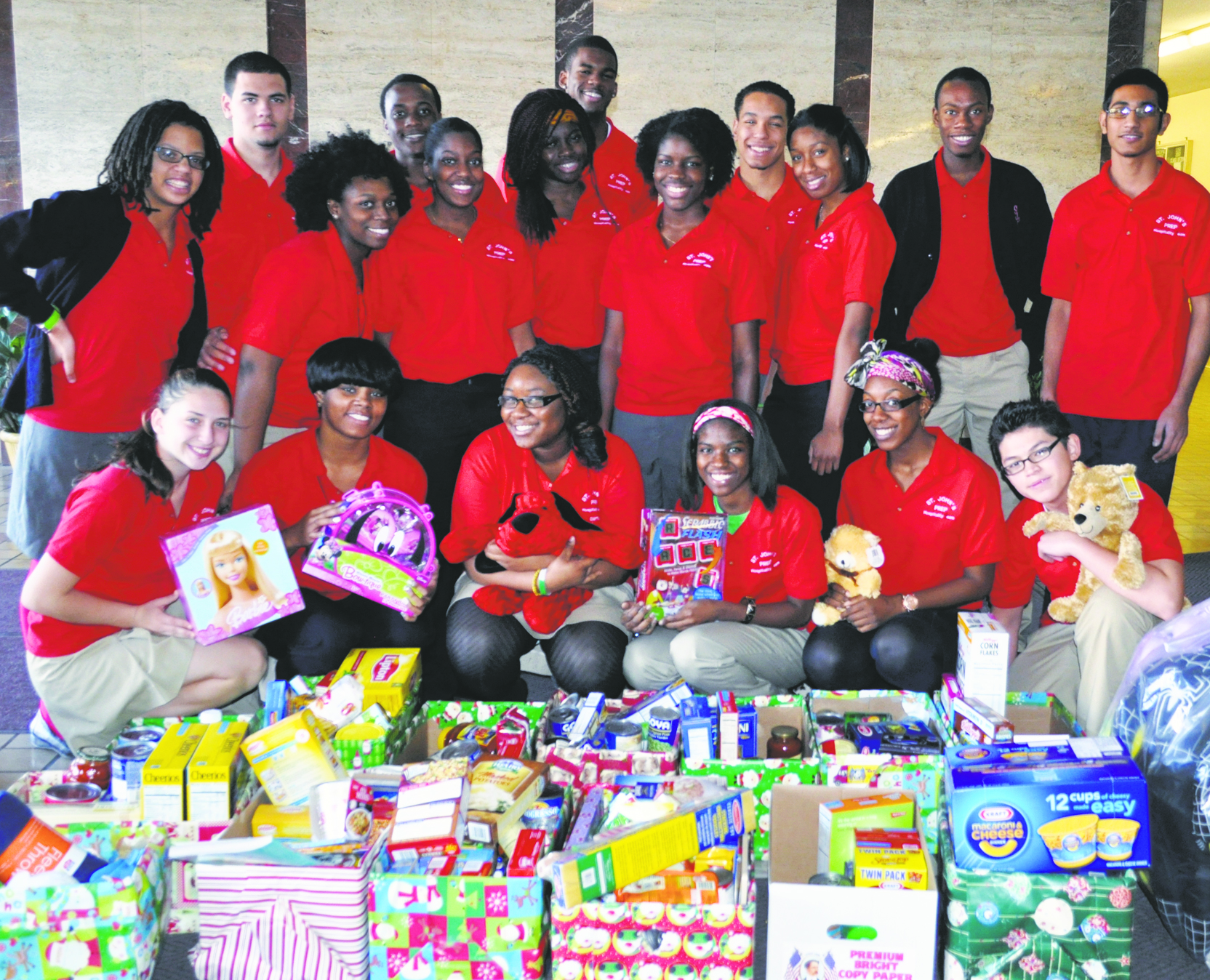 Above, St. John’s students are seen with food and toy donations before delivery to St. John the Baptist parish. 