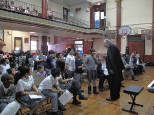 A student asks Bishop Nicholas DiMarzio a question during the “Stump the Bishop” session when the bishop visited Our Lady of Sorrows School, Corona, to celebrate Catholic Schools Week. (Photo by Antonina Zielinska)