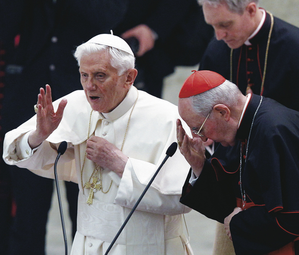 Pope Benedict XVI delivers his blessing during an audience with priests of the Diocese of Rome in Paul VI hall at the Vatican Feb. 14. At right is Cardinal Agostino Vallini, papal vicar of Rome. 