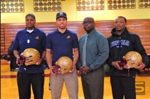 From left, Christ the King’s Terrence Brown, Jordan Fuchs, head coach Tyree Allison and James Coleman on National Signing Day.