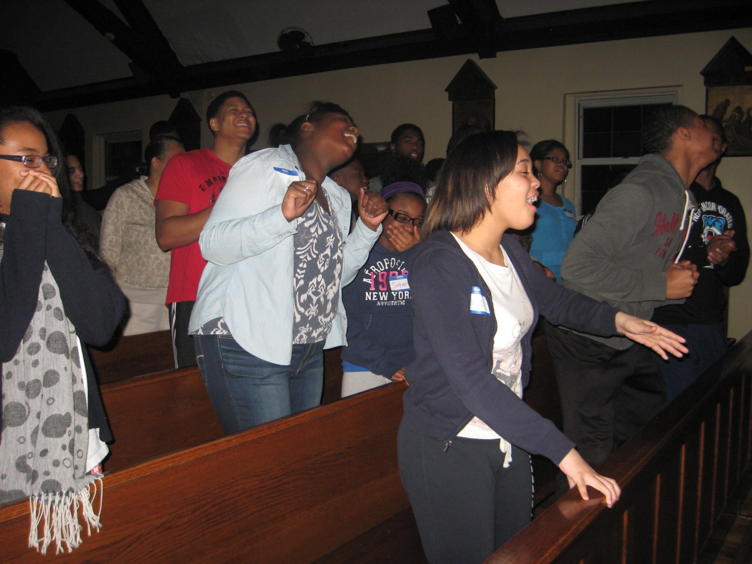 Photo by Maquane Dawson. Youth from Our Lady of Light parish, St. Albans, participate in praise and worship led by the New Name Band during their all-night retreat. 