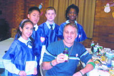 As part of the Little Doctors program, fourth and fifth graders at St. Athanasius School, Bensonhurst, hosted the school’s fifth annual Catholic Schools Week Blood Drive on Jan. 31. Above, the Little Docs don blue scrubs as they  provide juice and tend to Kenny Wodzanowski, director of the Bensonhurst Cluster Youth Ministry Office, one of 68 donors who rolled up their sleeves and donated.  If you would like to make a blood donation, you may schedule an appointment by calling 1-800-933-2566. 
