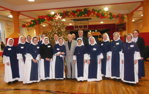 The Knights of Columbus from Archbishop John Hughes Council, No. 481, Dyker Heights, recently provided food donations to the Sisters of Life for the pregnant women, mothers and children in their care. Above, several officers from Archbishop Hughes Council, including Grand Knight Camillo Casano, visited with the Sisters and presented the donations during the Christmas season. (Photo courtesy Camillo Casano)