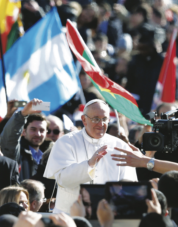 Pope Francis greets the crowd in St. Peter’s Square before celebrating his inaugural Mass at the Vatican March 19.