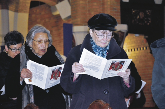 Women pray at Immaculate Heart of Mary Church, Windsor Terrace, during a special Mass of thanksgiving for the pontificate of Benedict XVI.