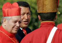 Venezuelan President Hugo Chavez, center, walks with Cardinal Jorge Urosa Savino of Caracas in this 2006 file photo. Chavez, the socialist president who transformed Venezuela while acting as chief protagonist in what was one of the worst Catholic Church-government relationships in Latin America, died March 5. He was 58. (CNS photo/Reuters) 