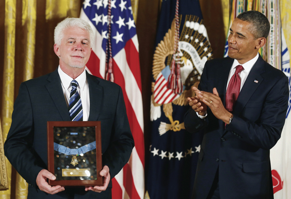 President Barack Obama presents the Medal of Honor to Ray Kapaun, who accepted it on behalf of his uncle, U.S. Army chaplain Father Emil Joseph Kapaun, at the White House in Washington, D.C. 