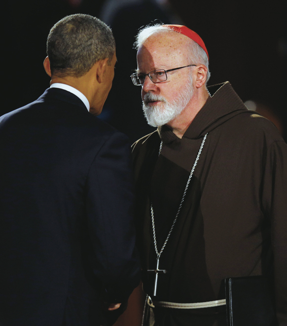 U.S. President Barack Obama talks to Cardinal Sean P. O’Malley of Boston during the “Healing Our City” interfaith memorial service at the Cathedral of the Holy Cross for the victims of the Boston Marathon bombing.