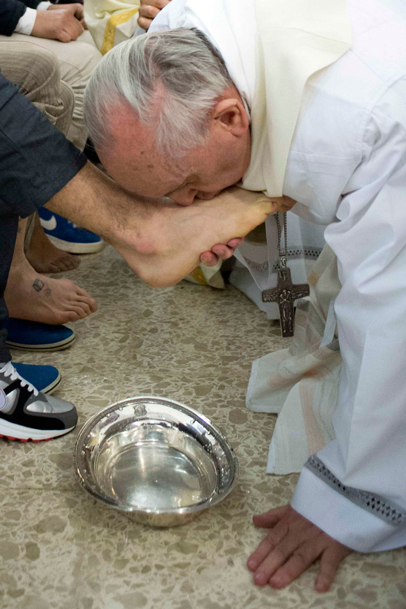Pope Francis kisses the foot of a prison inmate during the Holy Thursday Mass of the Lord’s Supper at Rome’s Casal del Marmo prison for minors.