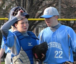 Sean, left, and Tim, right, McQuail discuss strategy prior to the start of an inning. (Photo by Jim Mancari)