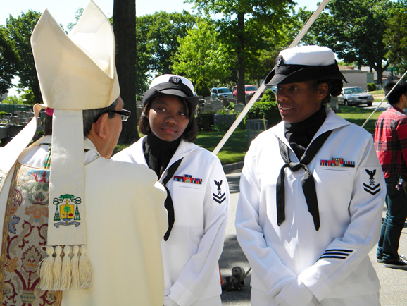 Bishop Octavio Cisneros chats with representatives of the U.S. Navy prior to the Memorial Day Field Mass at Mount St. Mary’s Cemetery, Flushing.