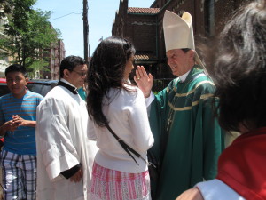 Cardinal Rubén Salazar Gómez blesses parishioners at St. Bartholomew’s Church in Elmhurst during a pastoral visit there on June 23.