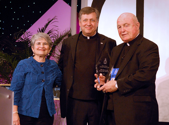 Bishop Sullivan receives Catholic Charities USA’s Vision Award at the organization’s annual gathering in New Orleans. Pictured with the bishop is Janet Valente Pape, chairwoman of the Catholic Charities USA board of trustees, and Father Larry Snyder, president of Catholic Charities.