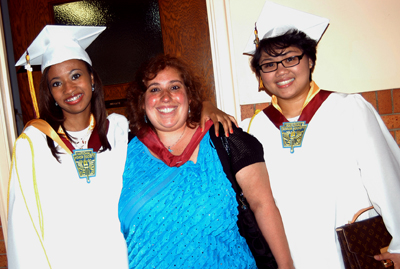 Maria Ortiz with two graduates.