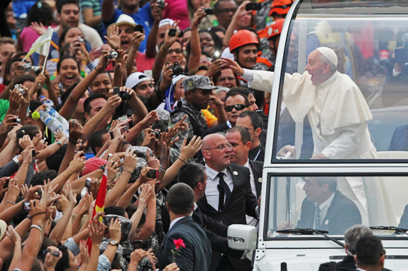 Pope Francis waves from his popemobile after arriving in Rio de Janeiro July 22. The pope is making his first trip outside Italy to attend World Youth Day, the international Catholic youth gathering.