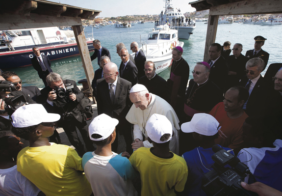 Pope Francis talks with immigrants at the port in Lampedusa, Italy, July 8. The pope called for repentance over treatment of migrants as he visited the Italian island where massive numbers of Africans have landed in attempts to reach Europe.