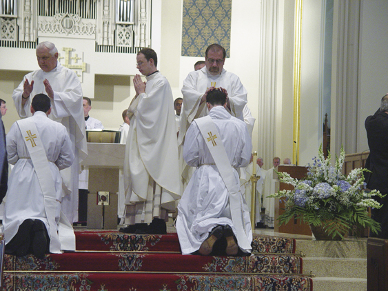 Bishop William Murphy of the Rockville Centre Diocese ordained Brandon Patrick O’Brien and Jason Umberto Grisafi to the diocesan priesthood on Saturday, June 22, at St. Agnes Cathedral, Rockville Centre, L.I. Among those participating were retired Brooklyn priest, Father Jame Devine, left, shown placing his hands on the head of ordinand, and Father James Cunningham, right, pastor of Holy Name parish, Park Slope, doing likewise.