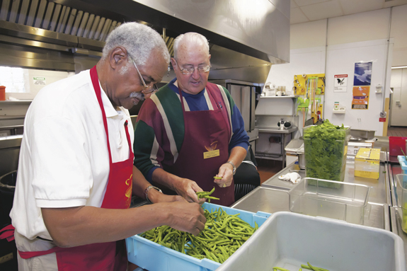 Volunteers at many social service programs, like this soup kitchen, come from those who retired.