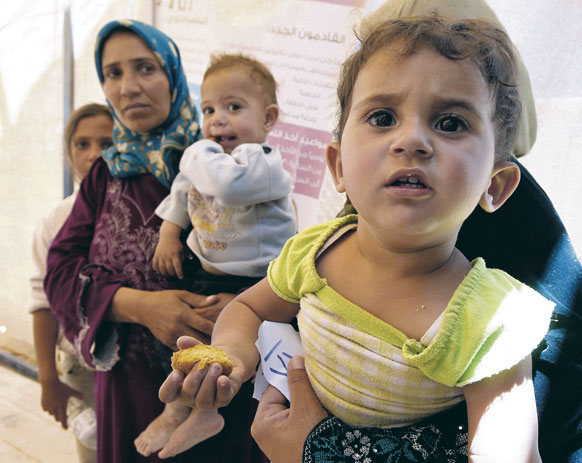Syrian refugees families await treatment at a medical center at the Al Zaatri refugee camp in Mafraq, Jordan.
