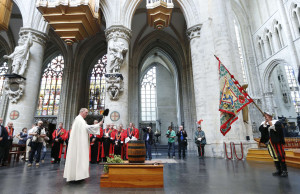 Priest blesses barrel of beer as members of the Knighthood of the Brewers' Mash staff take part in celebrations at cathedral in Brussels