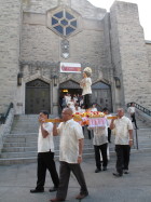 The Filipino community in Flushing begin their procession with their new statue of St. Lorenzo at Mary’s Nativity Church