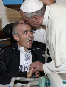 Pope Francis kisses a sick man inside the Basilica of Our Lady of Bonaria in Cagliari, Sardinia, Sept. 22. (Photo © Catholic News Service/Paul Haring)