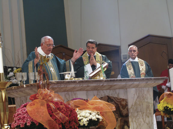 Bishop DiMarzio celebrates the centennial Mass at St. Athanasius Church, assisted by Msgr. David Cassato, pastor, and Father Ron D’Antonio, parochial vicar.