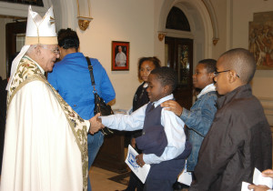 Retired Auxiliary Bishop Guy Sansaricq shook hands with Catholic school children as they were leaving St. James Cathedral-Basilica, Downtown Brooklyn, following an Oct. 9 Rosary Rally.