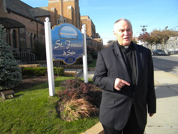 Msgr. John Brown, who was pastor of St. Francis de Sales, Belle Harbor, when Hurricane Sandy hit, paid a visit back to the neighborhood as the first anniversary of the storm arrived.