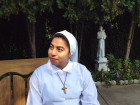 Postulant Iliana Maldonado, 21, sits near a statue of St. Francis outside the Monastery of St. Veronica Giuliani in Wilmington, Del. The Guatemalan native is living in the community of cloistered Poor Clare nuns to see if she is called to become a nun and follow the order’s life of poverty and service.