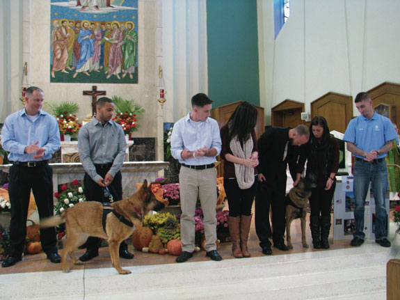 Bishop Kearney H.S., Bensonhurst, honored Marine service dogs and their handlers during a special Mass in St. Athanasius Church. Above, standing from left, are Sgt. Willingham, Sgt. Lucca, Cpl. Rodriguez and his wife, Sgt. Riddle and Jony. 
