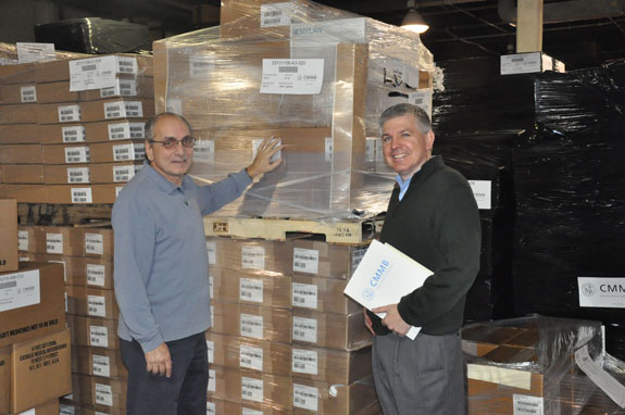Ralph Barberio, left, manager of the Catholic Medical Mission Board distribution center in Long Island City, and Adrian Kerrigan, senior vice president for advancement, inspect a shipment of medical supplies bound for the Philippines.