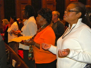 From left, Rosa Charles, Sonia Charlot and Jean Taylor – members of the local Pro Sanctity Movement – pray the Our Father at Mass on the “Day of Universal Sanctification,” held Nov. 9 at St. Margaret’s Church, Middle Village. (Photo by Jim Mancari)