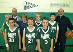 Father Sean Suckiel, far right, is the head coach of the Blessed Trinity parish, Breezy Point, CYO boys’ sixth-grade basketball ‘B’ team. (Photo by Jim Mancari)