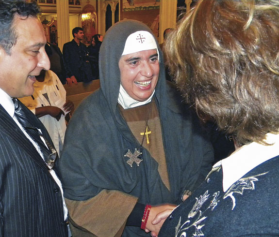 Mother Agnes-Mariam of the Cross greets guests Dec. 6 after her talk at St. Nicholas Antiochian Orthodox Cathedral, Downtown Brooklyn. The talk was part of a six-week speaking tour throughout the U.S. and Canada.