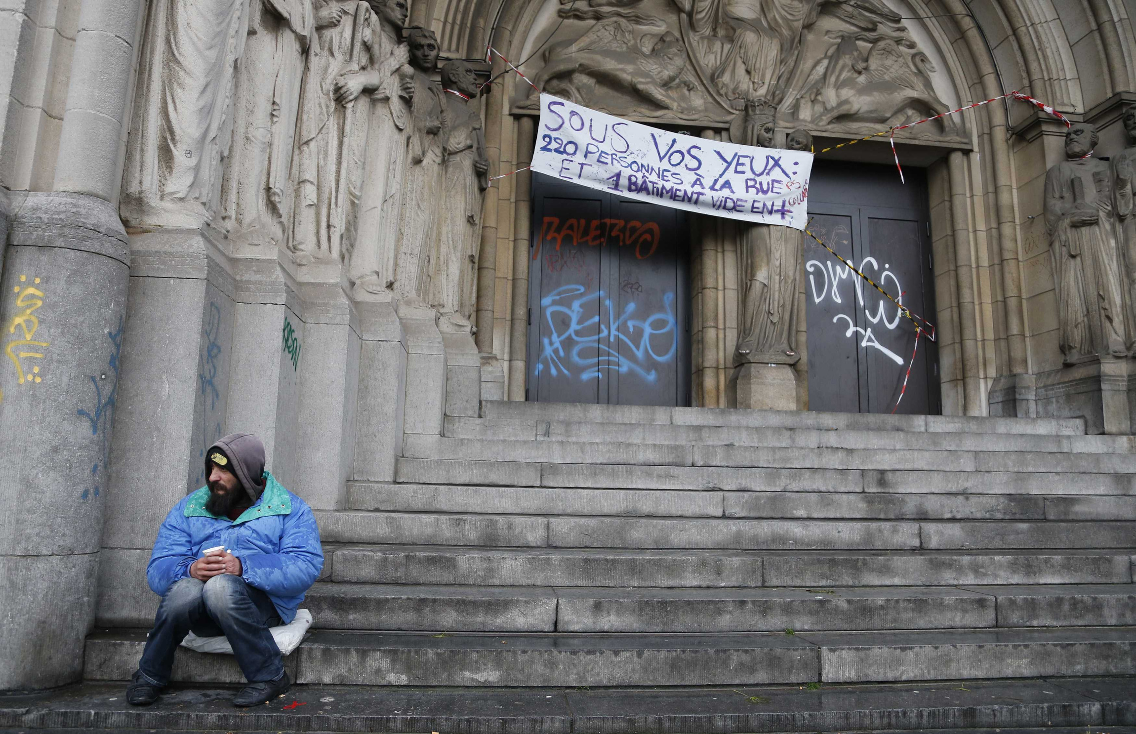 A panhandler sits at the entrance of an abandoned convent in Brussels. Pope Francis will help launch a global campaign of prayer and action against world hunger. Organized by Caritas Internationalis, the Vatican-based federation of Catholic Charities, the global “wave of prayer” will begin at noon Dec. 10 on the South Pacific island of Samoa and head west across the world’s time zones.