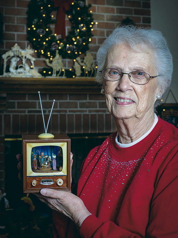 Verna Bechard, a Catholic parishioner in New London, Wis., holds one of nearly 200 Nativity sets she has collected over six decades.