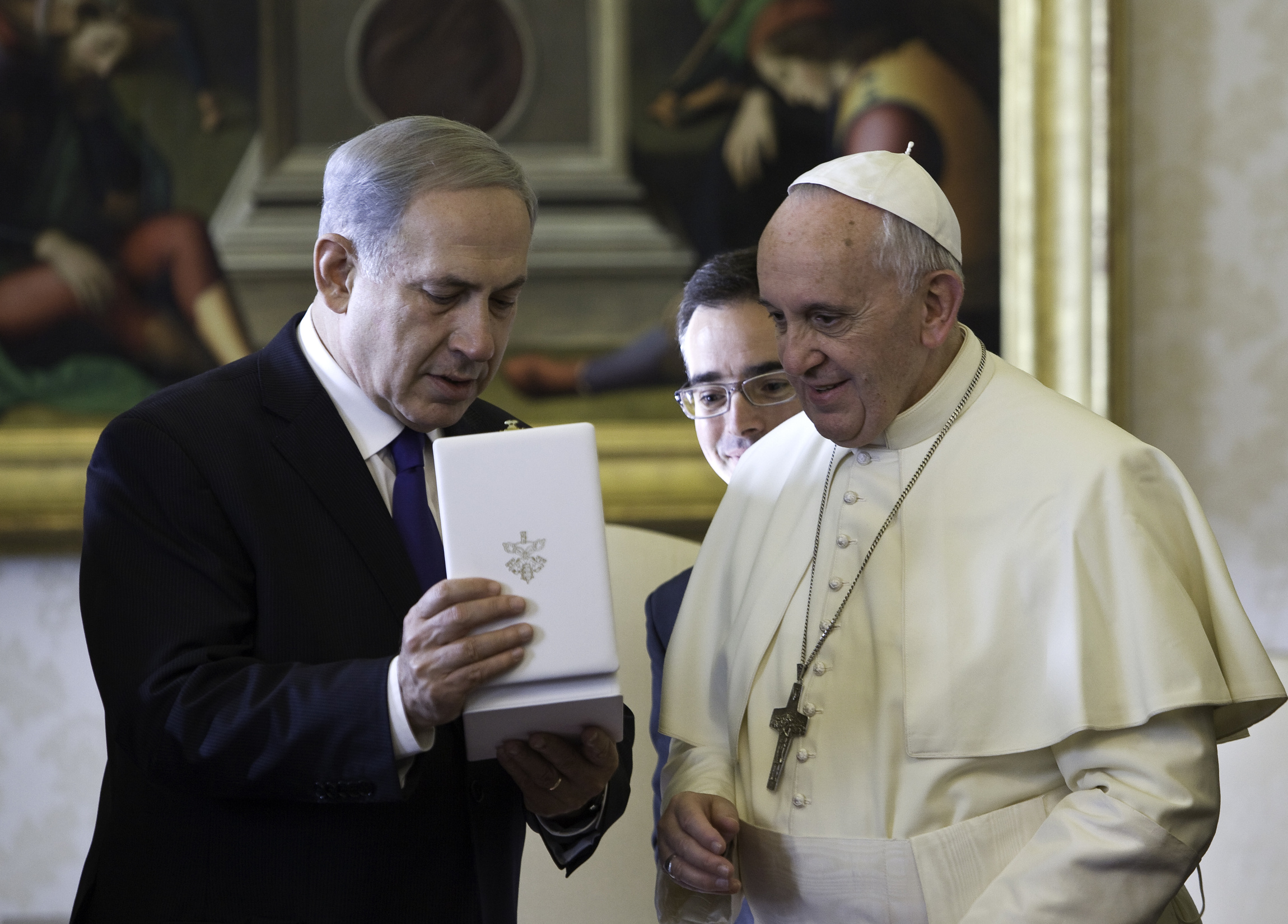 Pope Francis presents a gift to Israeli Prime Minister Benjamin Netanyahu during a private audience at the Vatican Dec. 2. 