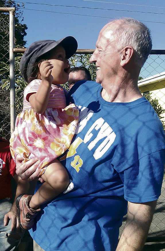 Father Robert Whelan greets a young resident of a Mustard Seed Community in Nicaragua.