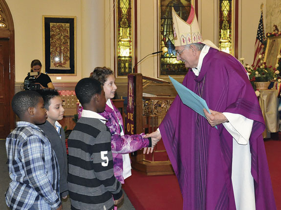 Bishop Nicholas DiMarzio greets the children of the religious education program at Our Lady of Mount Carmel, Astoria.