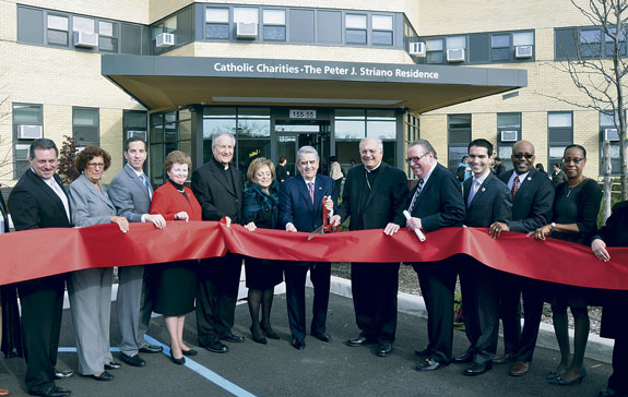 Peter Striano cuts the ribbon marking the opening of the senior housing in Howard Beach named in his honor. He was joined by Bishop Nicholas DiMarzio, leaders of Catholic Charities and government officials who teamed up to make the project possible.