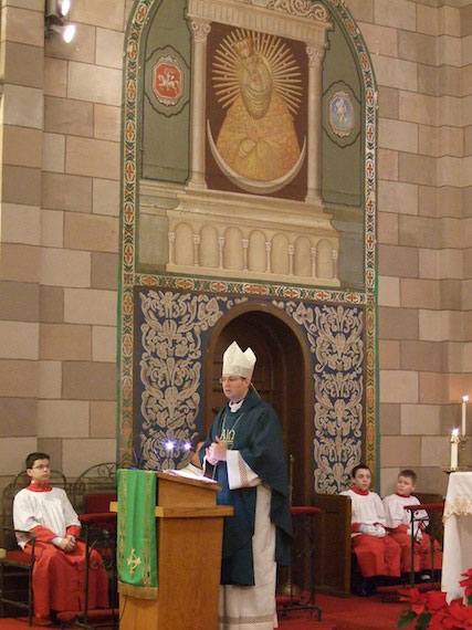 Bishop Kestutis Kevalas preaches to the Lithuanian community of Annunciation parish. Above him is a painting of Our Lady of Vilnius.